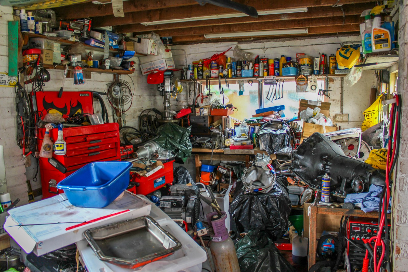 A garage packed floor to ceiling with tools, boxes, bins and equipment